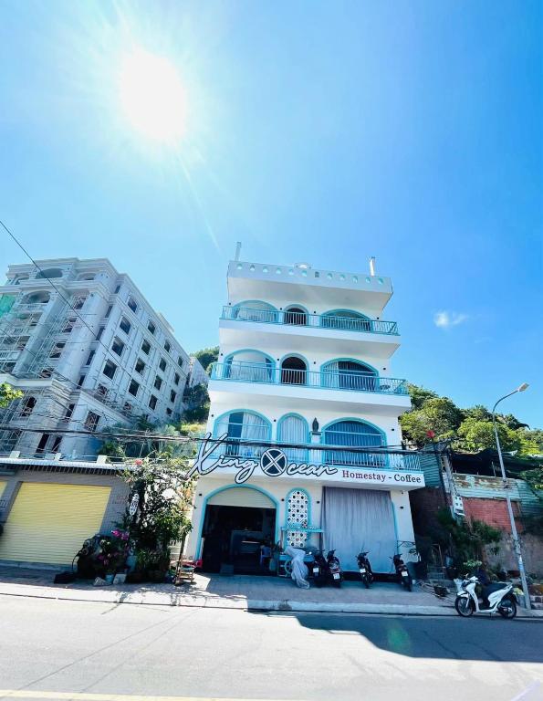 a large white building with motorcycles parked in front of it at Xing Ocean Vũng Tàu in Vung Tau