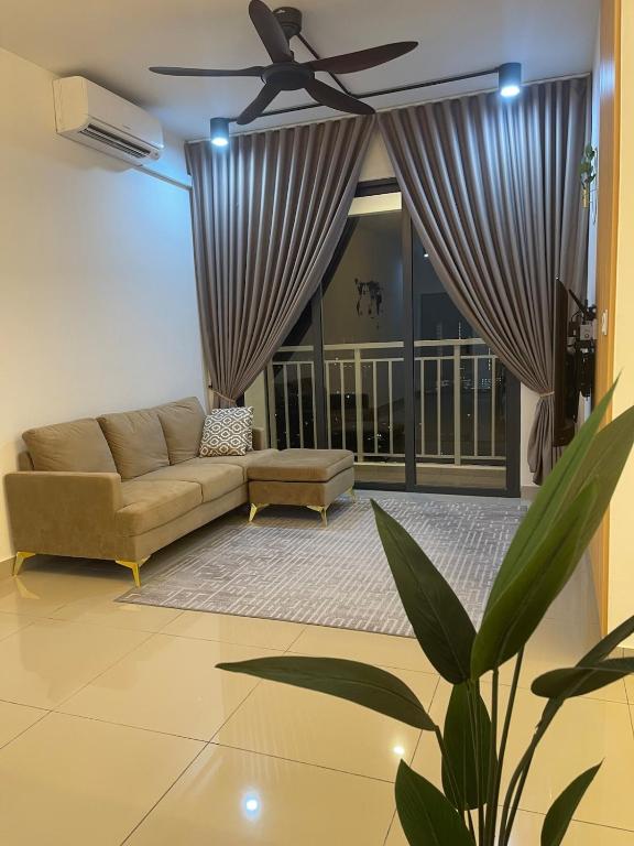 a living room with a couch and a ceiling fan at RumaDuke Kuala Lumpur with Netflix and KLCC Views in Kuala Lumpur