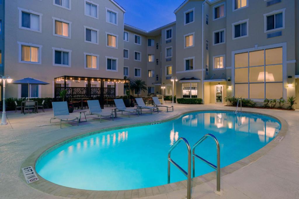 a swimming pool in front of a building at Homewood Suites by Hilton Bonita Springs, FL in Bonita Springs