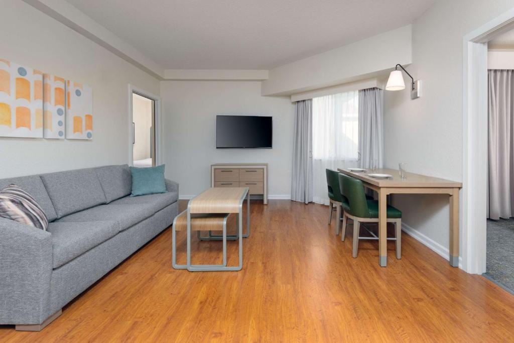 a living room with a couch and a table at Homewood Suites by Hilton Bonita Springs, FL in Bonita Springs