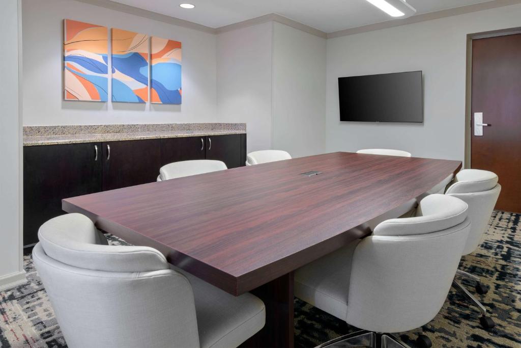a conference room with a wooden table and chairs at Homewood Suites by Hilton Bonita Springs, FL in Bonita Springs