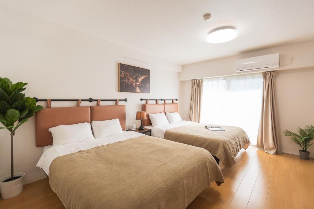 Postel nebo postele na pokoji v ubytování b&天下茶屋店
