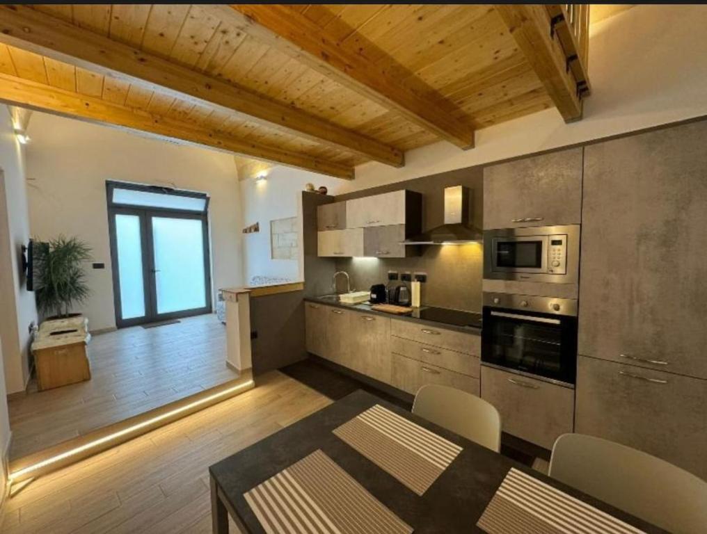 a kitchen with a table and a dining room at A Volte nel Salento-Porta Napoli in Lecce