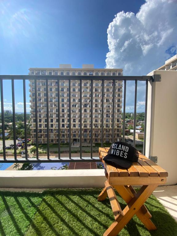 a balcony with a bench and a large building at Affordable Staycation near Airport and beach in Suba