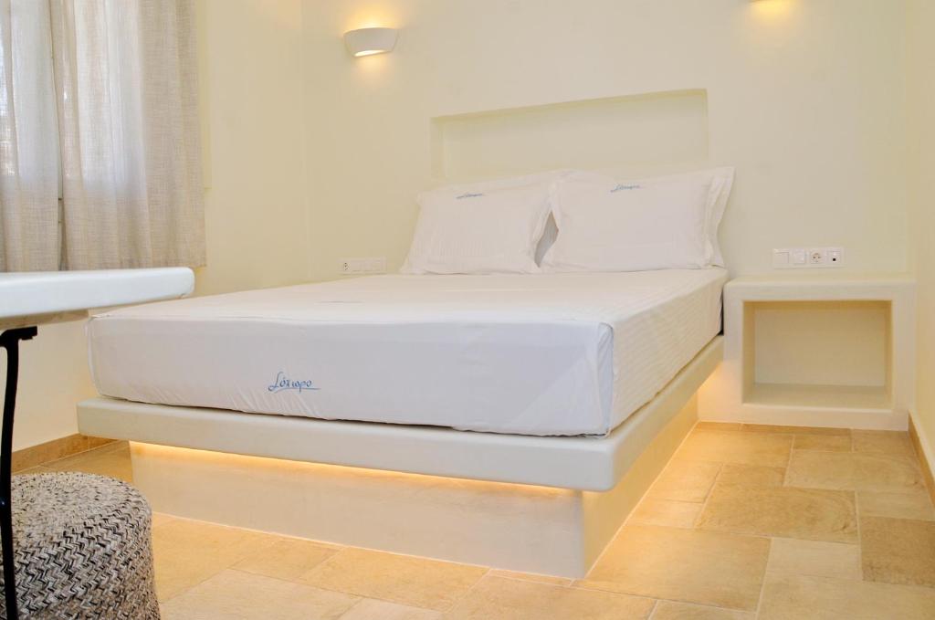 a bedroom with a white bed in a room at Sohoro in Koufonisia