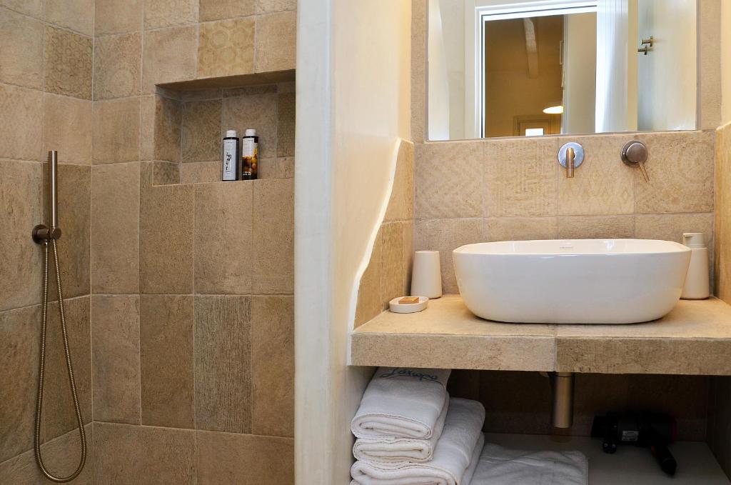 a bathroom with a sink and a shower at Sohoro in Koufonisia