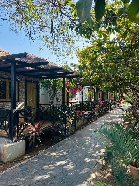 a row of tables and chairs next to a building at Raghunandan Resort Cottages in Nashik