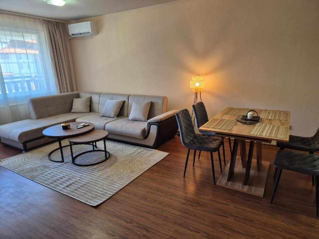 a living room with a couch and a table at Ski Holiday accommodation in Bansko