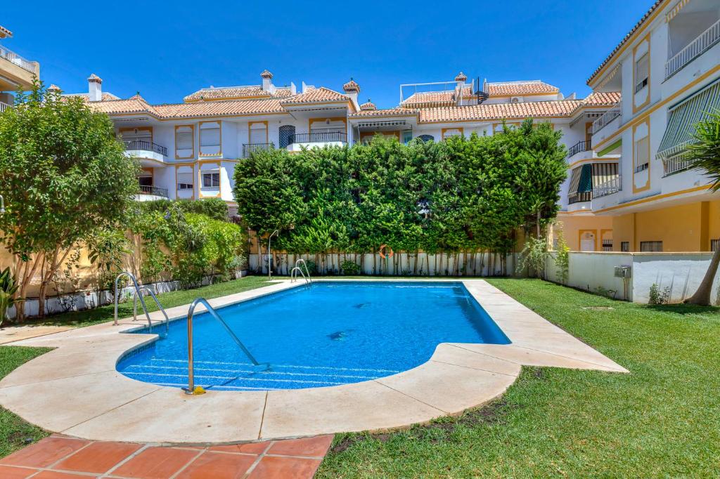 a swimming pool in the yard of a house at Coral Apartment La Cala Beach in La Cala de Mijas