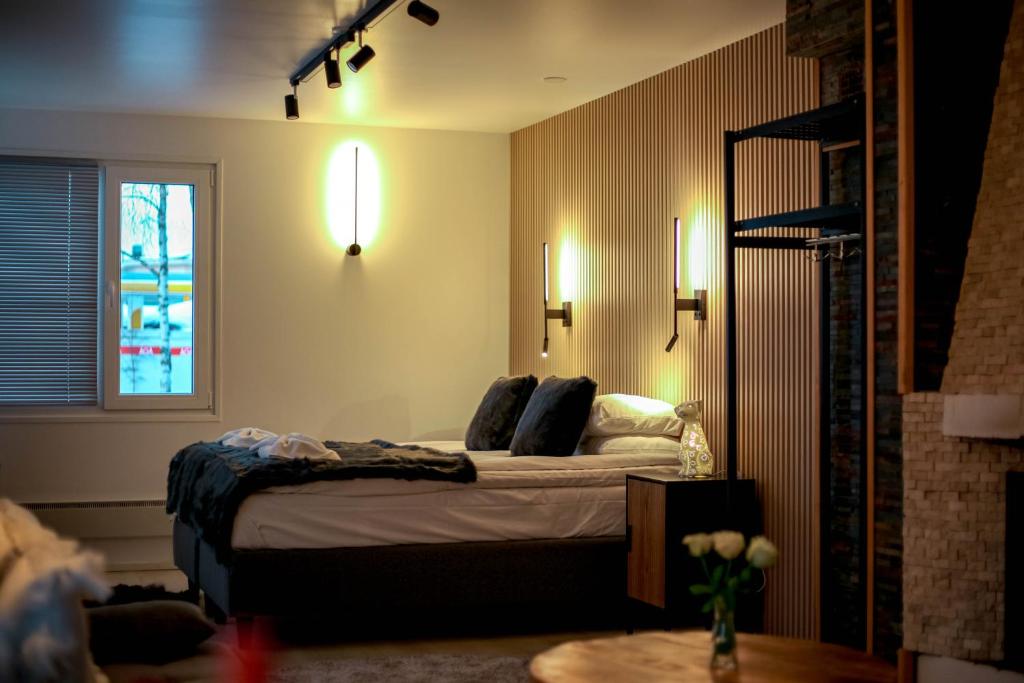 a bedroom with a bed and a window and lights at Cityview Studio in Inari