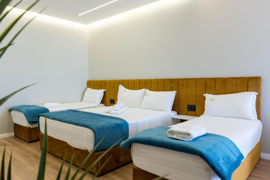 Postel nebo postele na pokoji v ubytování Golemi Lux Hotel