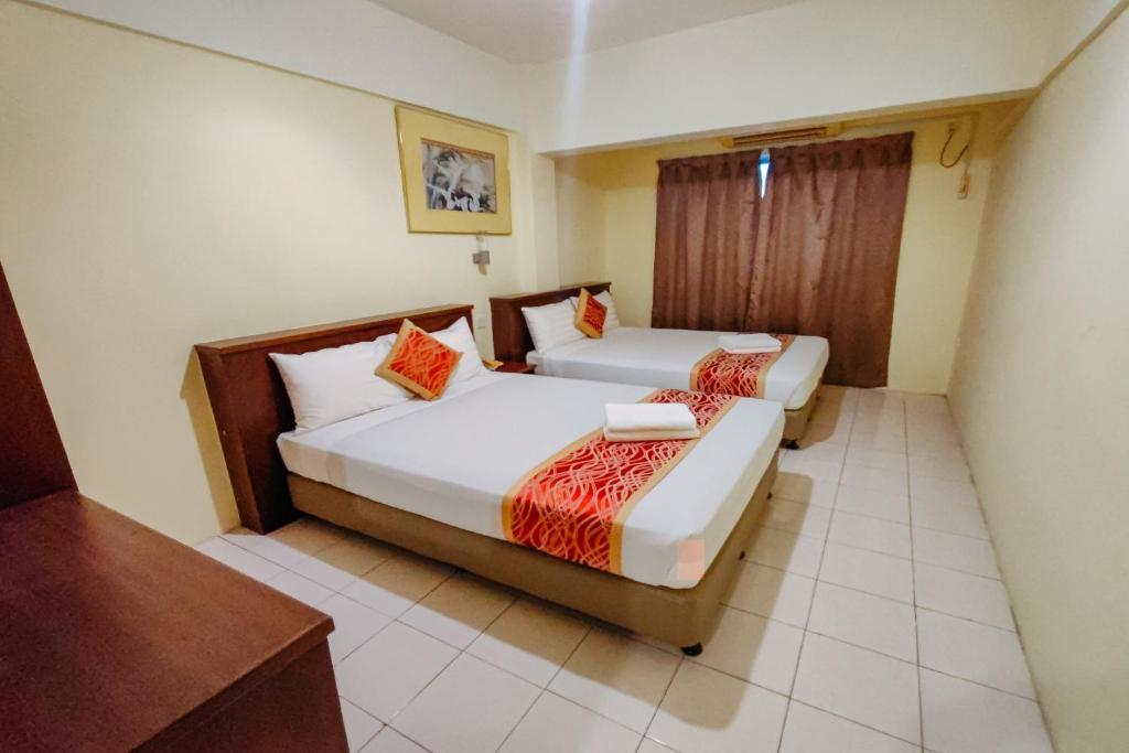 Postel nebo postele na pokoji v ubytování Virgo Batik Resort Teluk Batik Lumut