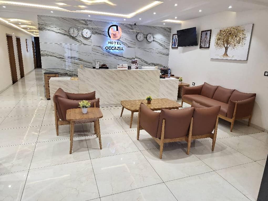 a lobby with couches and tables in a store at Hotel Occazia Lubumbashi in Lubumbashi