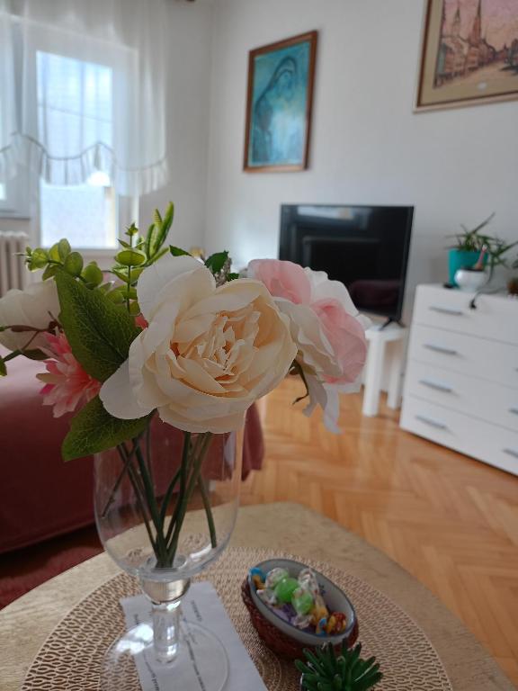a vase of flowers on a table in a living room at Kleopa in Pale