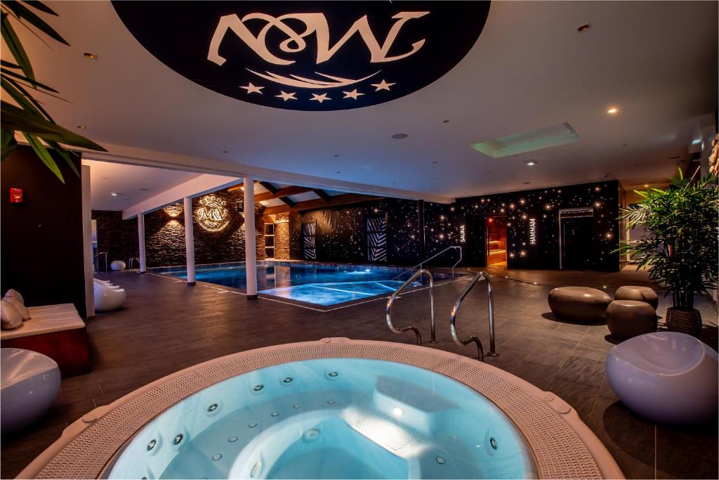 a room with a jacuzzi tub in the middle of a building at M&V Resort Camping in Langrune-sur-Mer