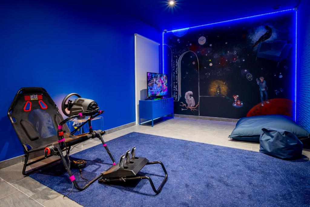a room with a star wars bedroom with a blue wall at M&V Resort Camping in Langrune-sur-Mer