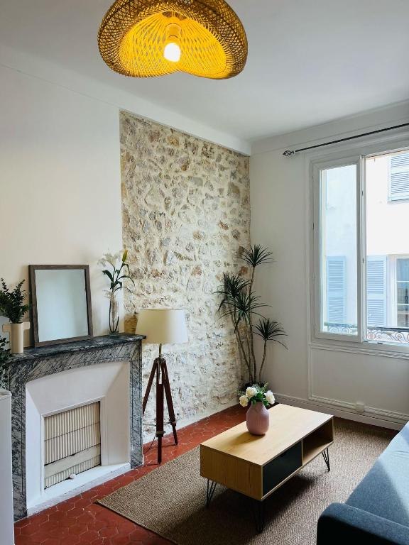 un salon avec une cheminée et une table dans l'établissement Studio en plein coeur du Vieil Antibes, vue sur place romantique, à Antibes