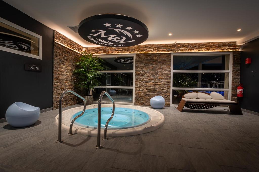 a jacuzzi tub in the middle of a room at M&V Resort Camping in Langrune-sur-Mer