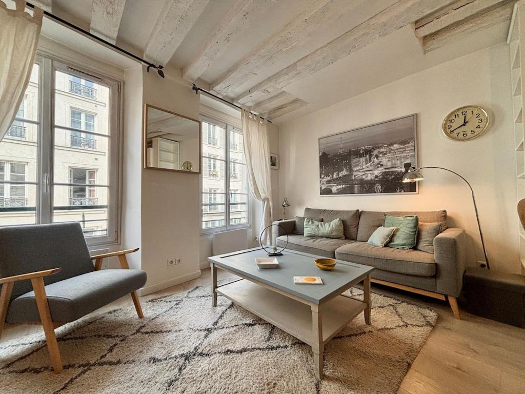 un salon avec un canapé et une table basse dans l'établissement Appartement de Charme à Montorgueil, à Paris