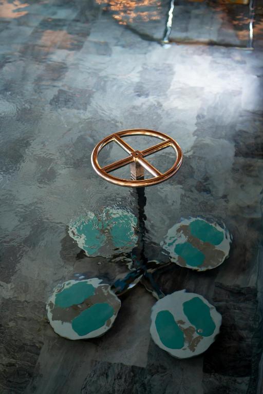 a metal object sitting in a puddle of water at M&V Resort Camping in Langrune-sur-Mer