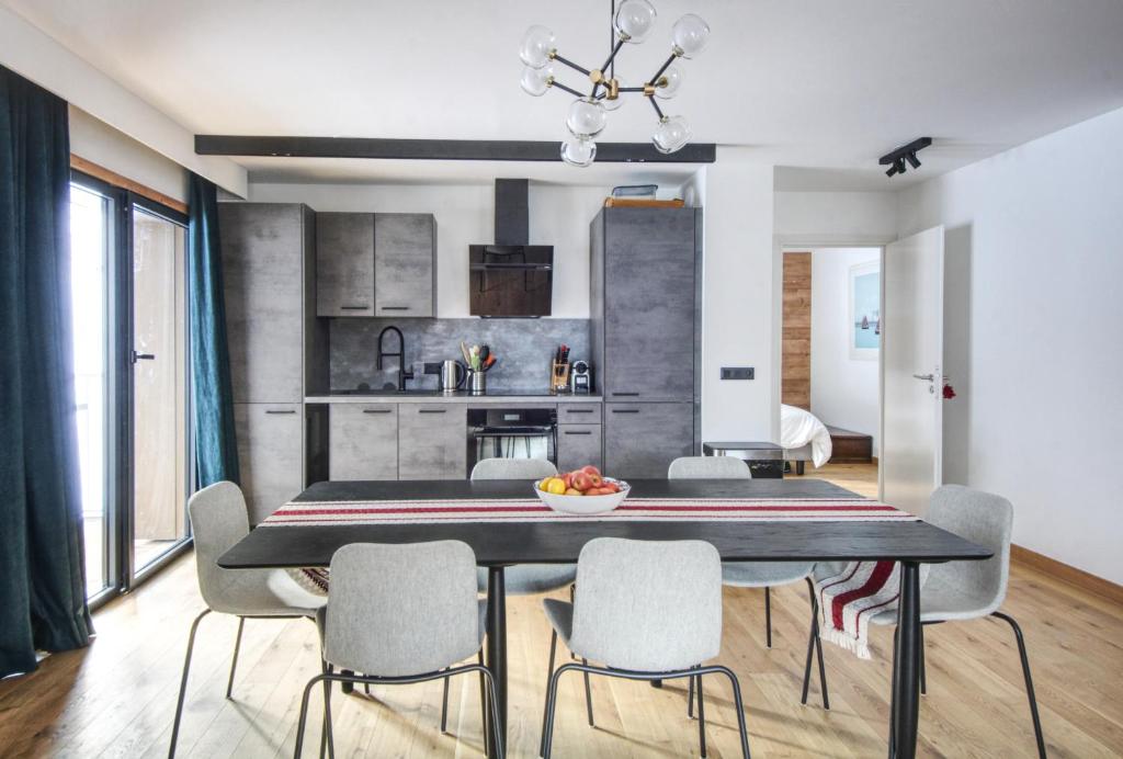 a kitchen and dining room with a table and chairs at Apartment Aiguille Rose in Les Houches