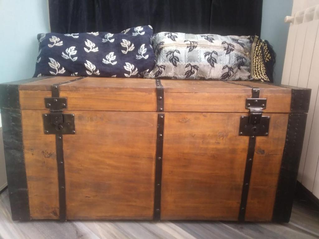 a large wooden chest with a couch on top of it at San Salvario No cooking between history and nightlife in Turin