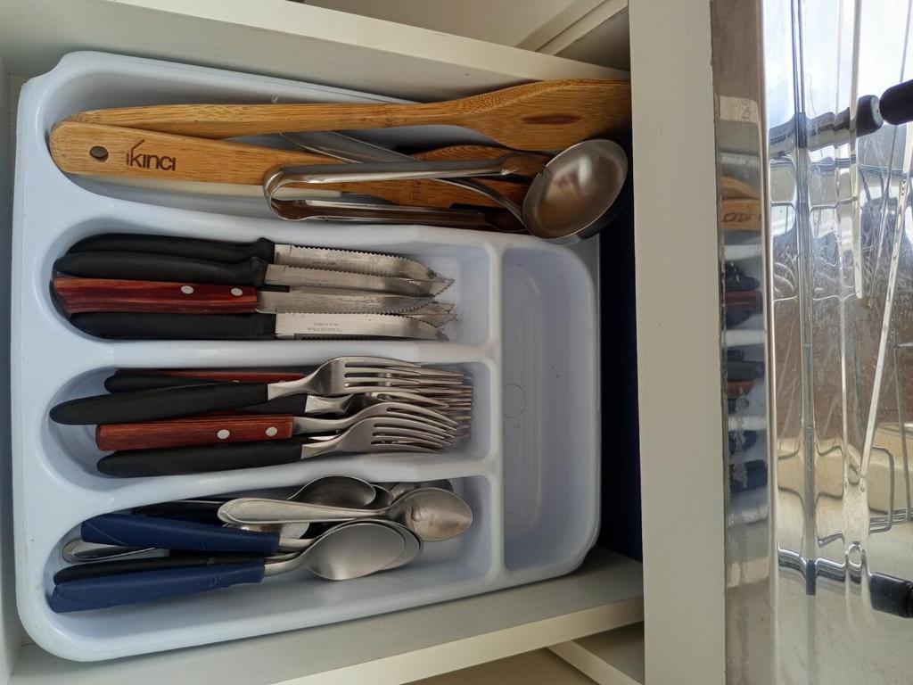 a white drawer filled with utensils in a kitchen at Joinville Apartamento in Joinville