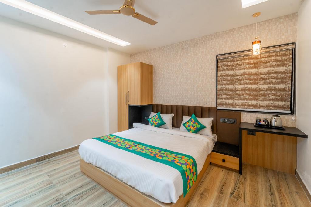 a bedroom with a large bed in a room at Treebo Neel Orchid in Ujjain