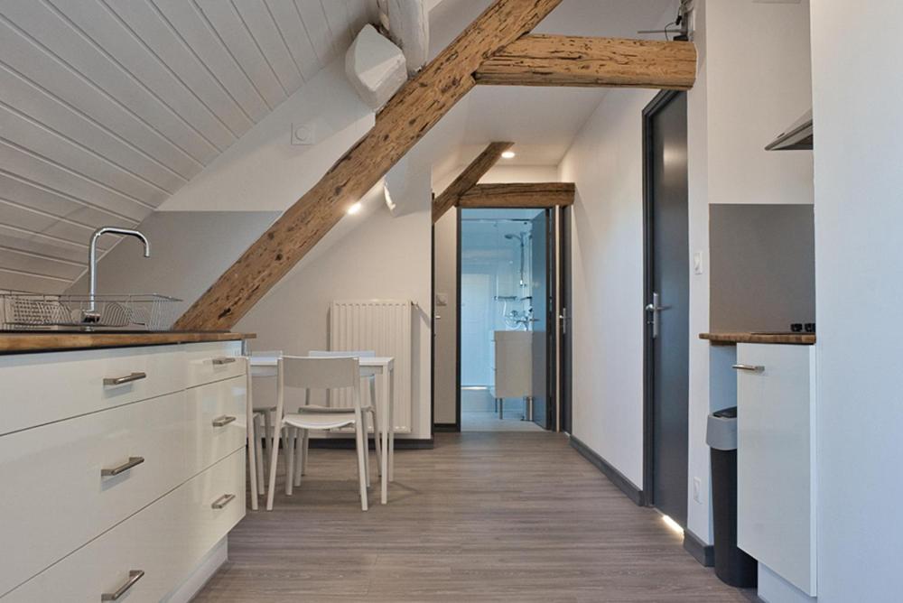 a kitchen with a table and a dining room at Chambres privées au calme avec espaces partagés in Metz