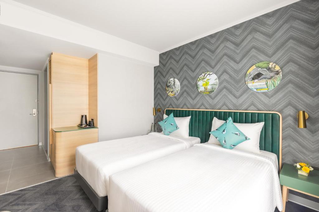 Postel nebo postele na pokoji v ubytování ibis Styles Mysuru