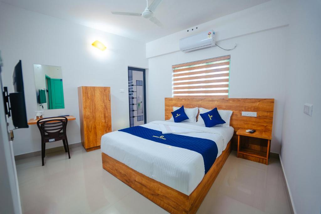 Postel nebo postele na pokoji v ubytování Breeza Homes, Technopark, Trivandrum