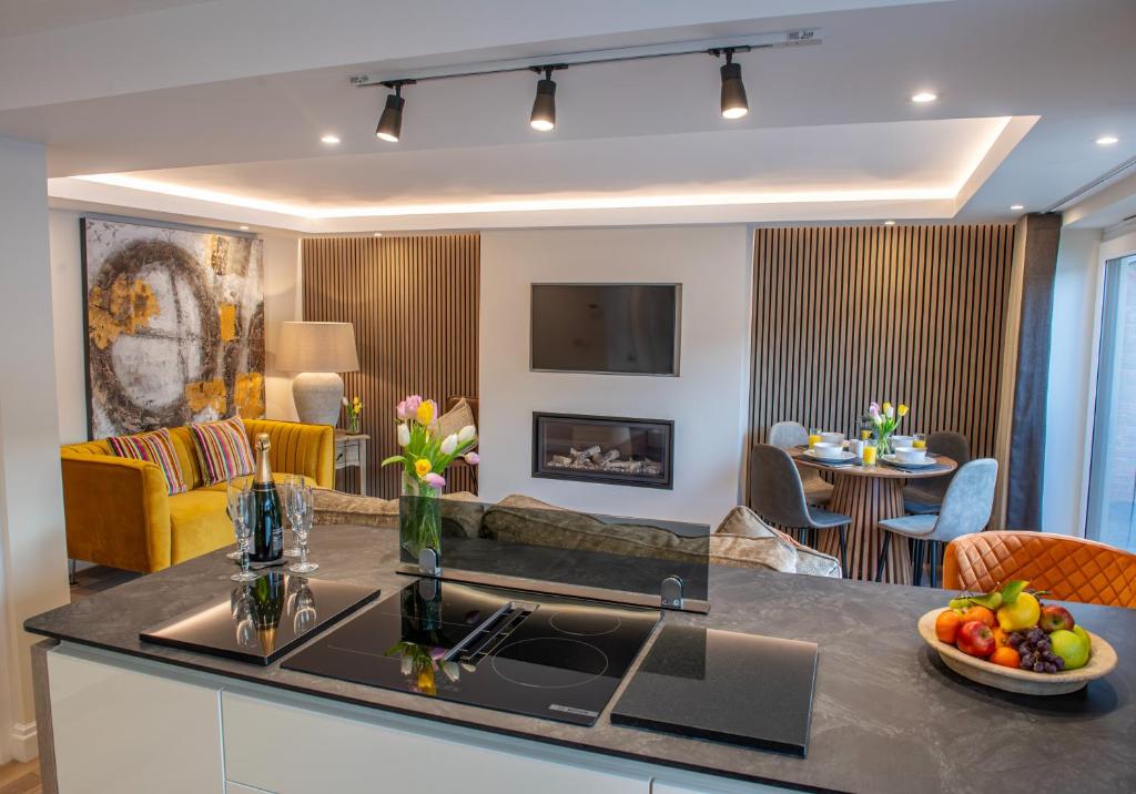 a kitchen and living room with a couch and a table at Scallop Lodge Lytham in Lytham St Annes