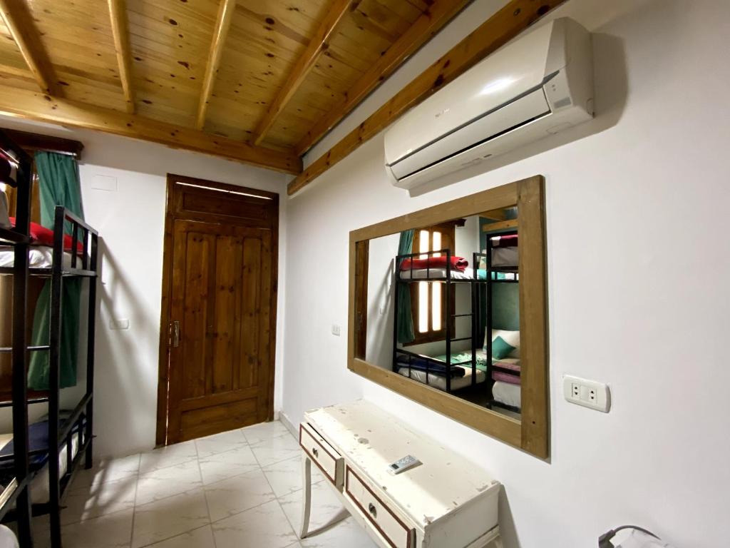a bathroom with a mirror and a sink in a room at Octopus Hotel in Dahab