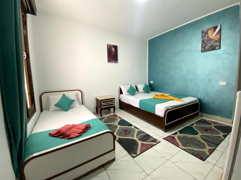 a room with two beds in a room at Octopus Hotel in Dahab