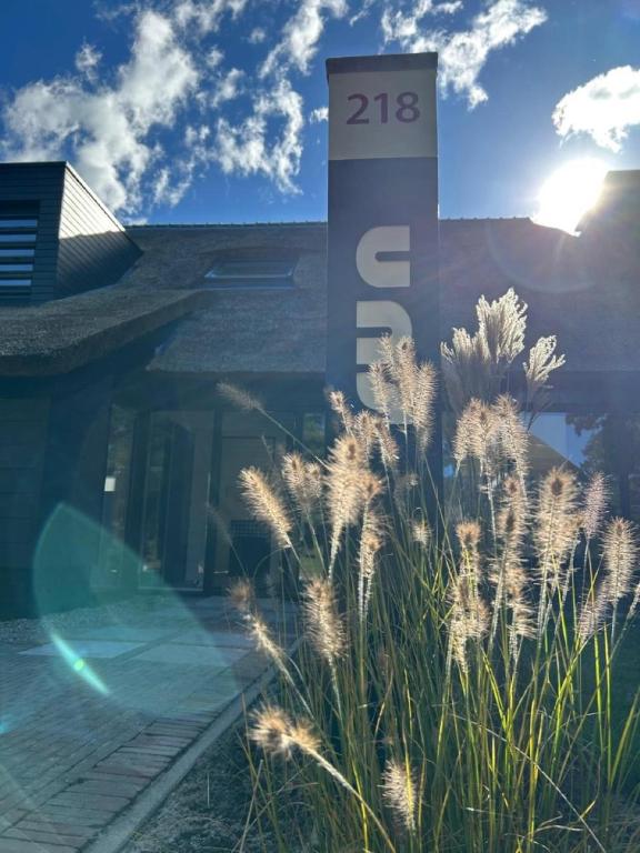 a sign in front of a house with grass at Villa Sun in Ballum