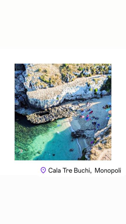an aerial view of a beach with rocks and water at Paradise Sea Terrace in Monopoli