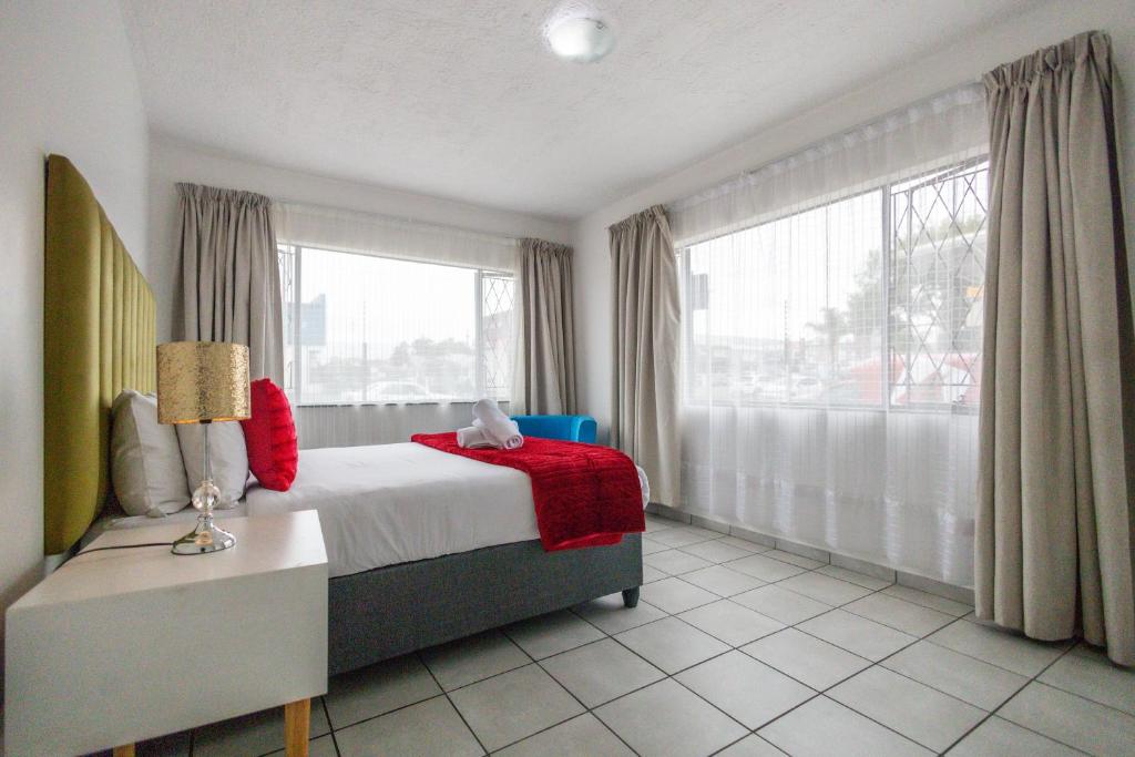 a bedroom with a bed and a large window at Safi Luxury Apartment 2 in East London