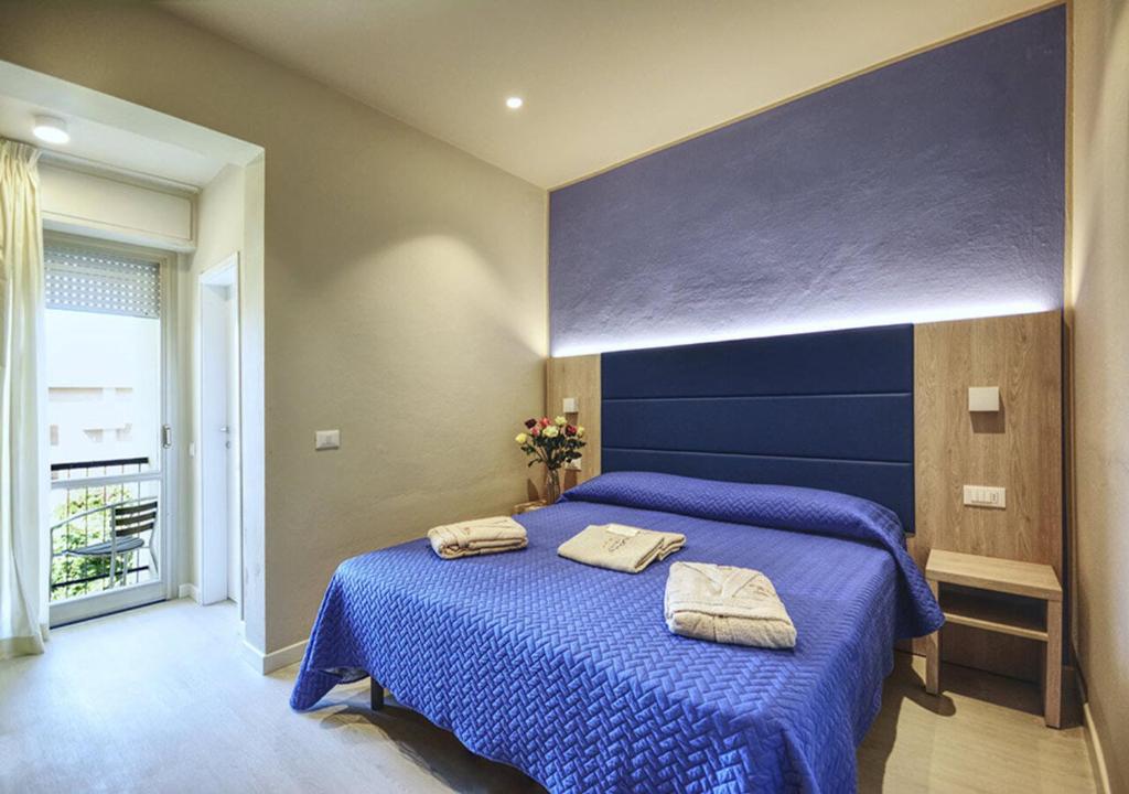 Postel nebo postele na pokoji v ubytování Hotel Pironi