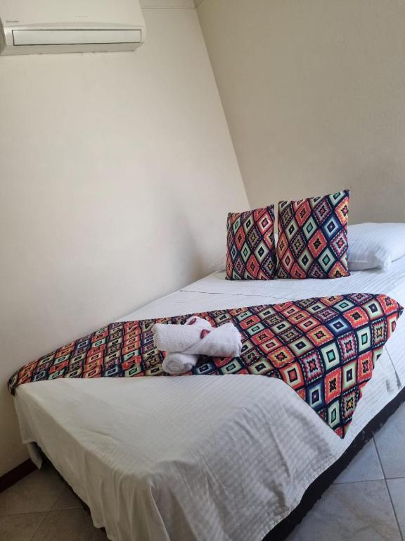 Postel nebo postele na pokoji v ubytování Hotel Tierra Santa Santa Fe de Antioquia