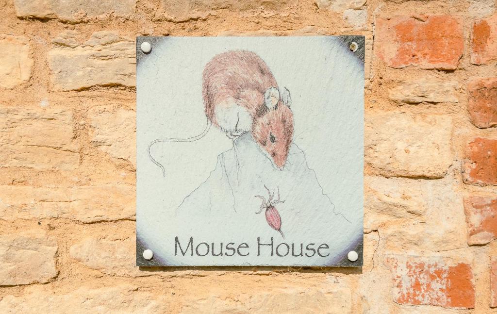 a sign for a mouse house on a brick wall at Mouse House at Tove Valley Cottages in Towcester