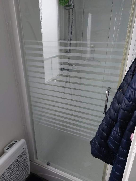 a shower with a glass door in a bathroom at Le paradis de la côte d opale in Camiers