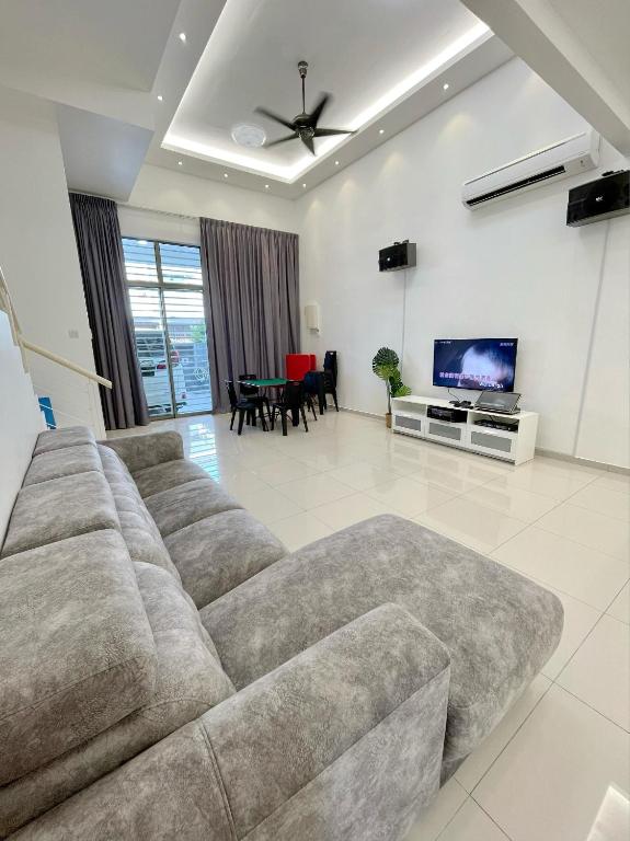 a living room with a couch and a tv at Kuala Selangor 93 in Kuala Selangor