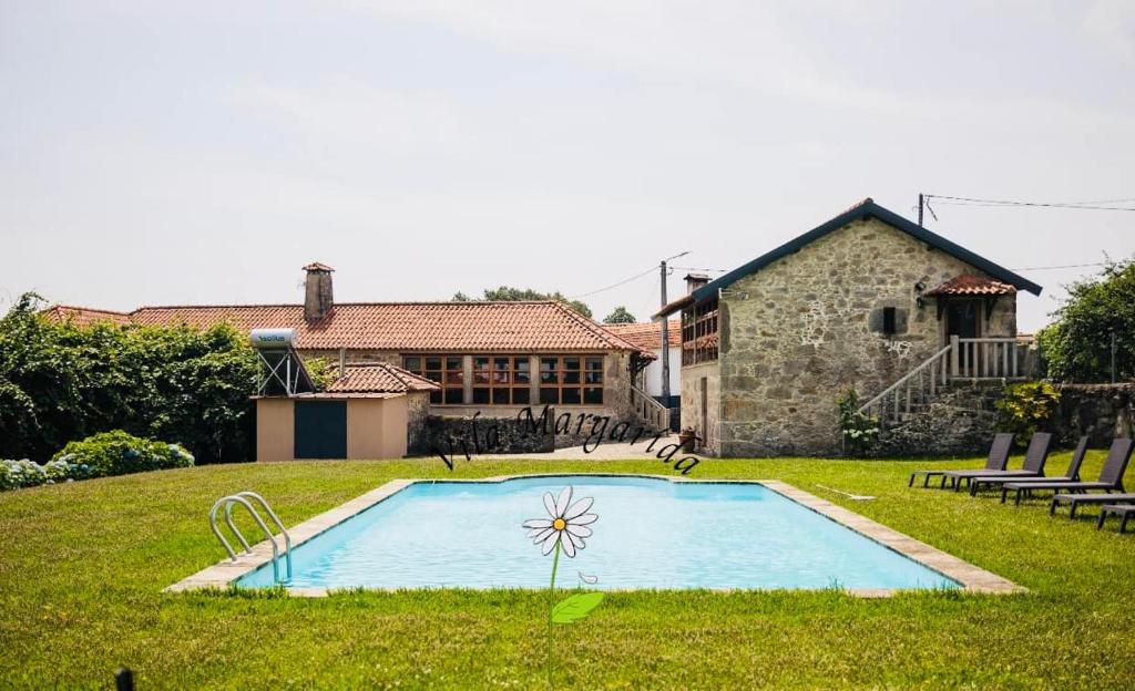 a swimming pool in the yard of a house at Vila Margarida in Porreiras