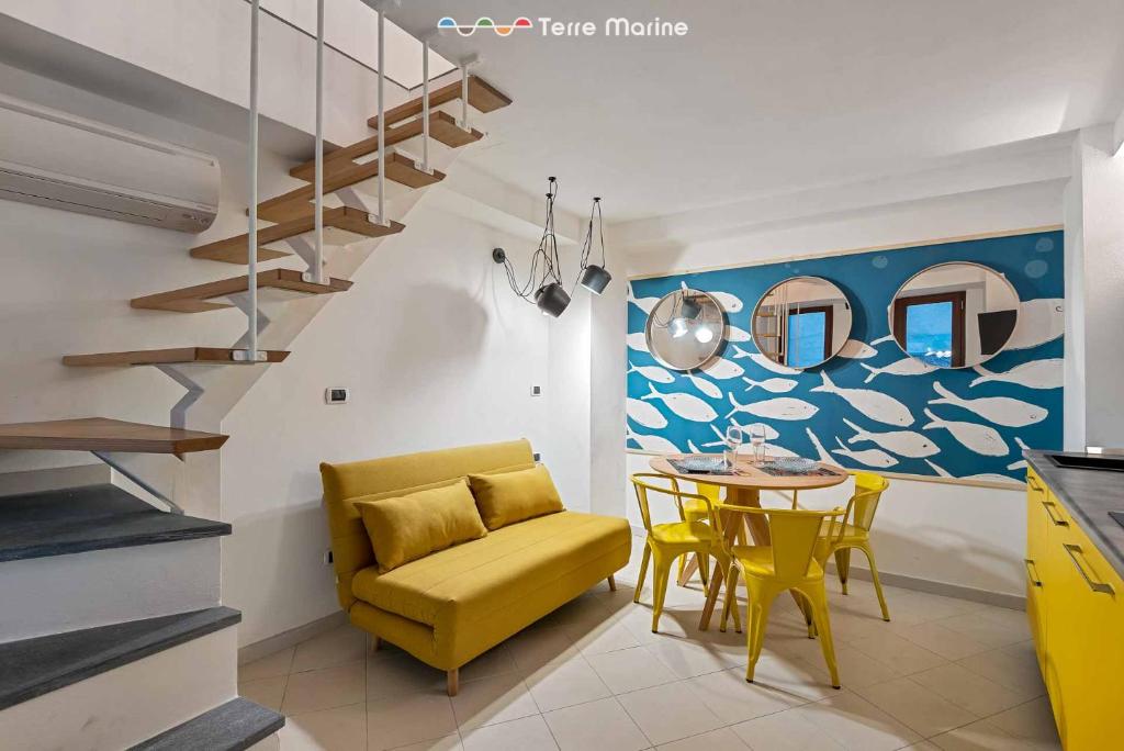 a living room with a yellow chair and a table at Yellow Submarine, Terre Marine in Manarola
