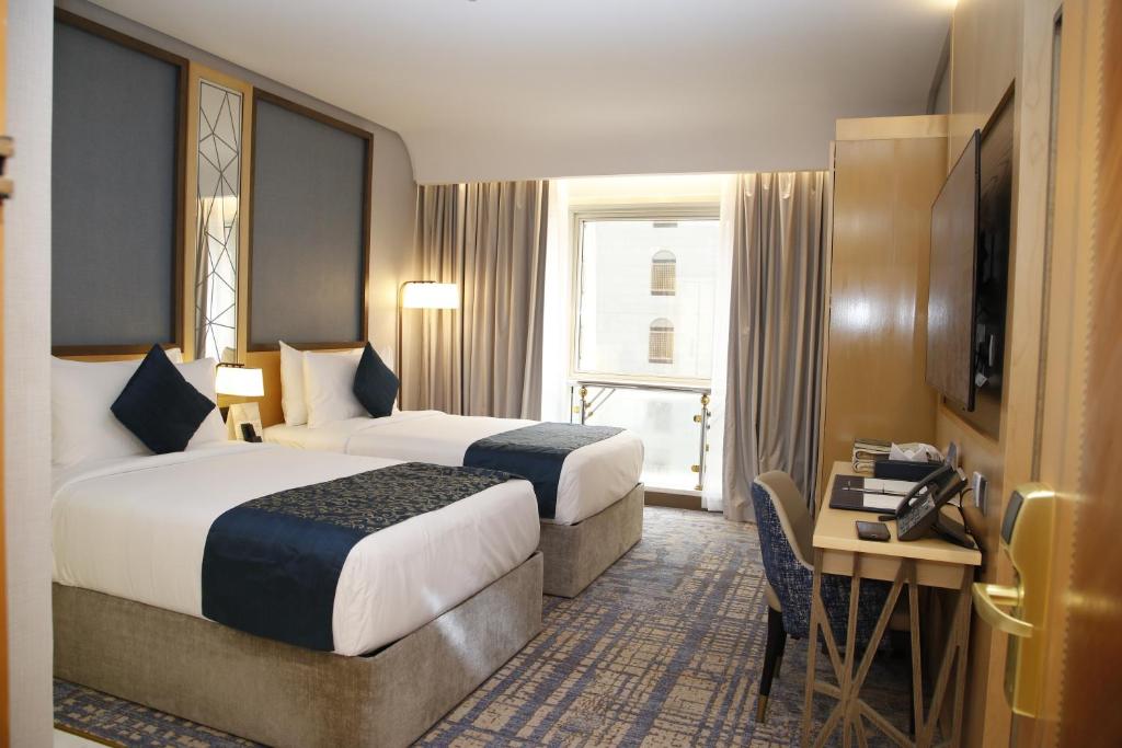 MADEN Al Rawda مادن الروضة tesisinde bir odada yatak veya yataklar