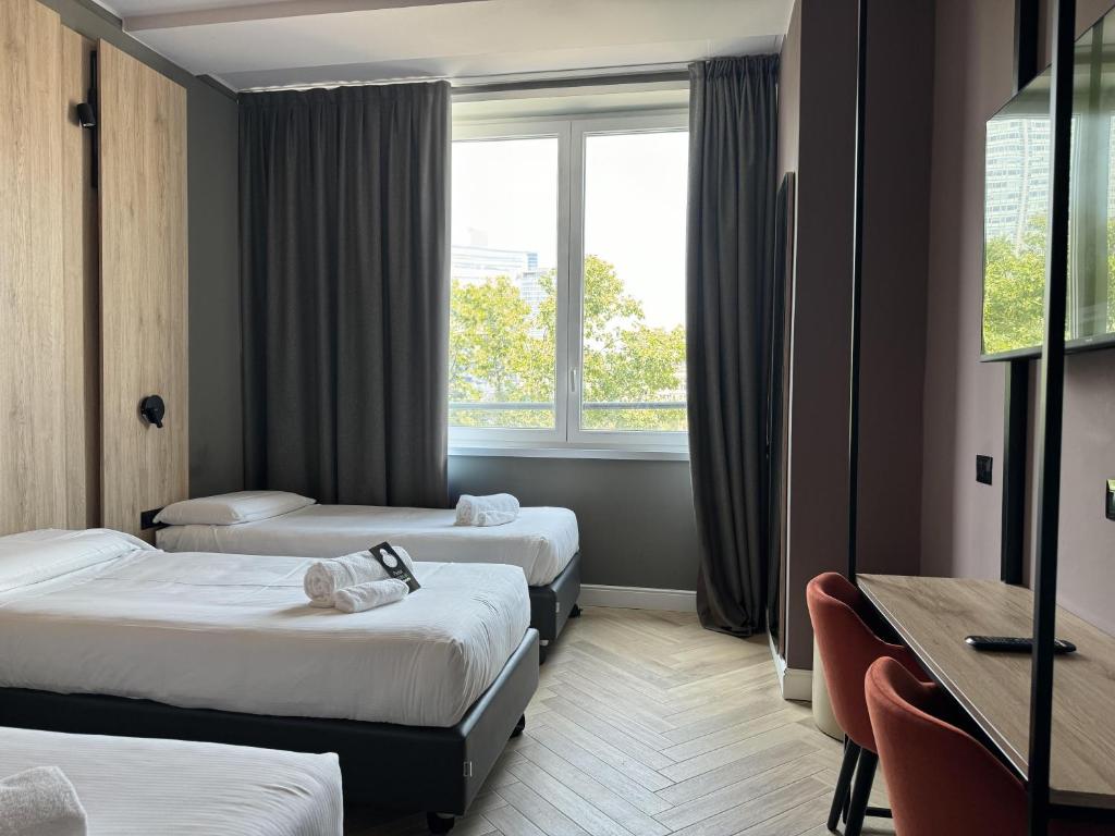 Postel nebo postele na pokoji v ubytování B&B Hotel Milano Aosta