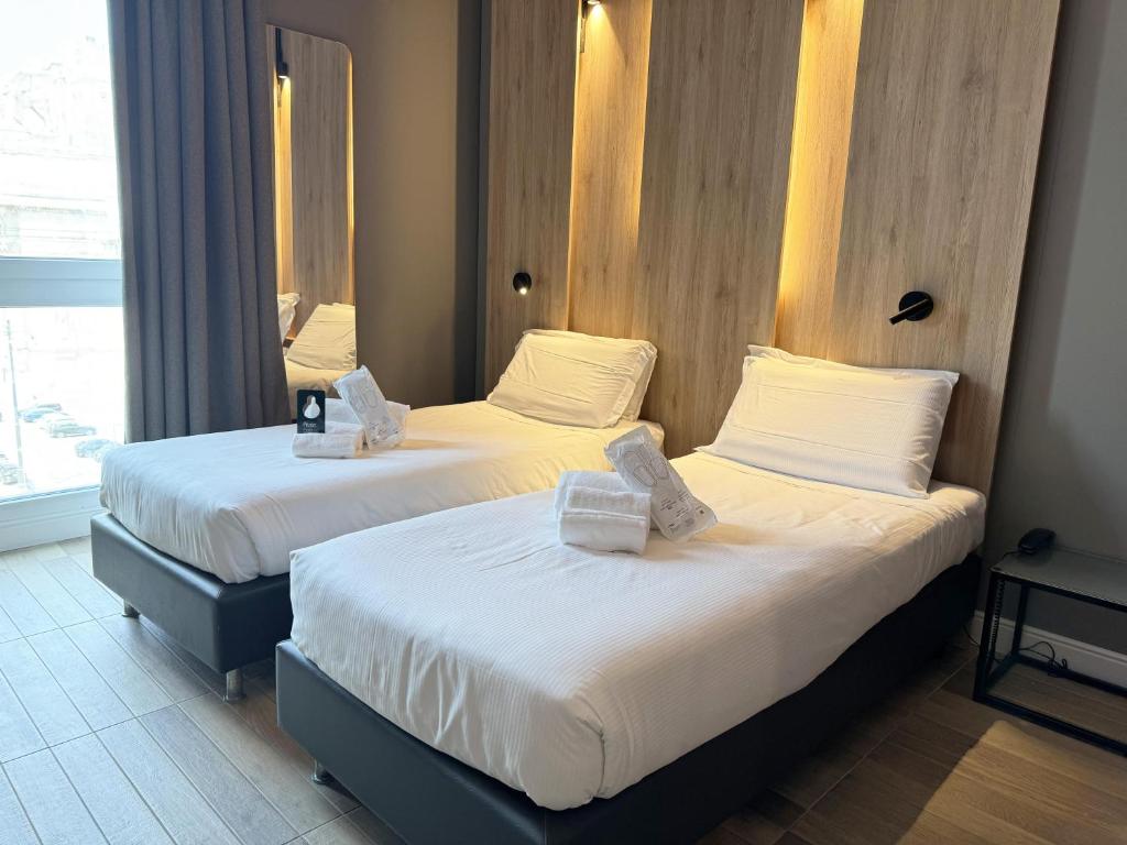 Postel nebo postele na pokoji v ubytování B&B Hotel Milano Aosta