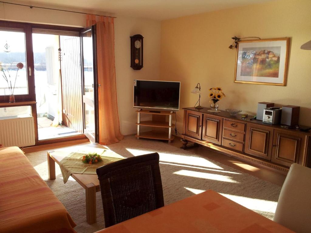 a living room with a flat screen tv on a dresser at Ferienwohnung Meier in Kressbronn am Bodensee