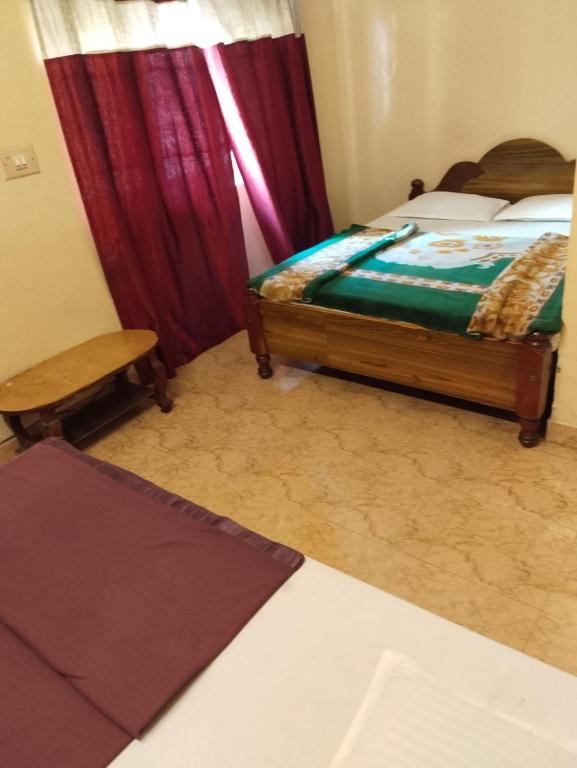 Postel nebo postele na pokoji v ubytování NKF Residency mysuru