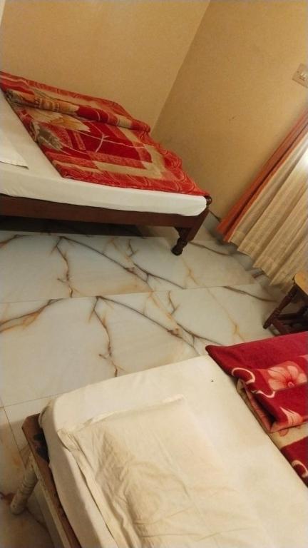 Postel nebo postele na pokoji v ubytování NKF Residency mysuru